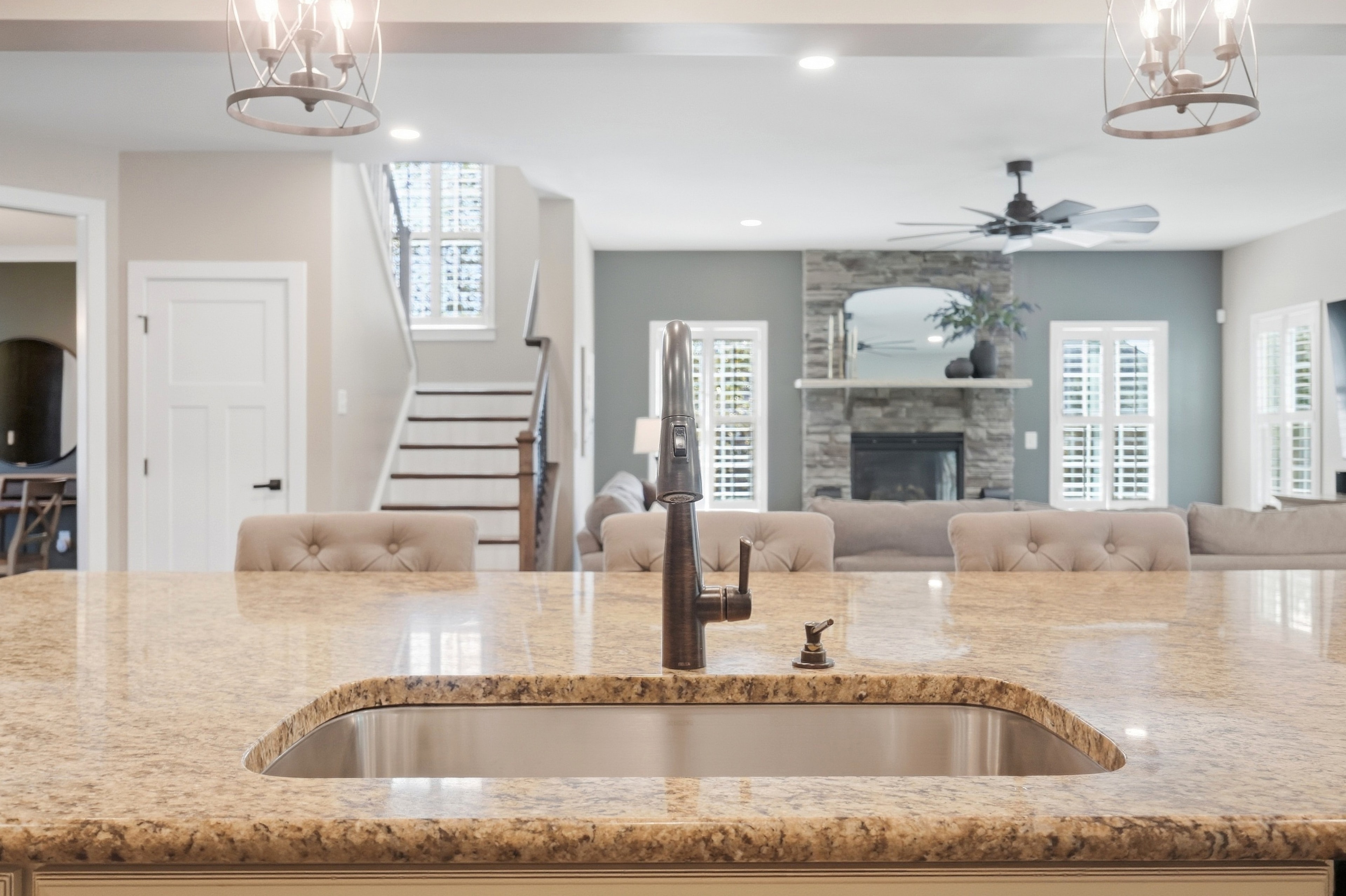 Island sink — granite countertop & open-concept view