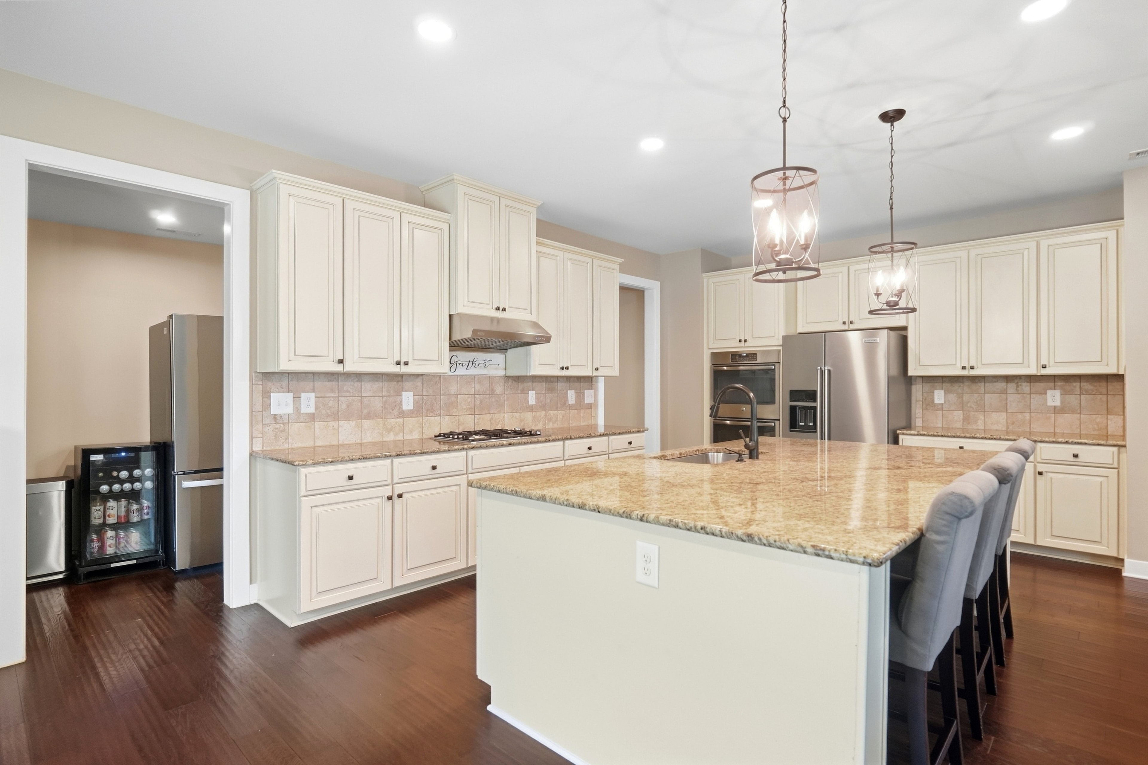 Kitchen — full view with cream cabinetry & stainless appliances