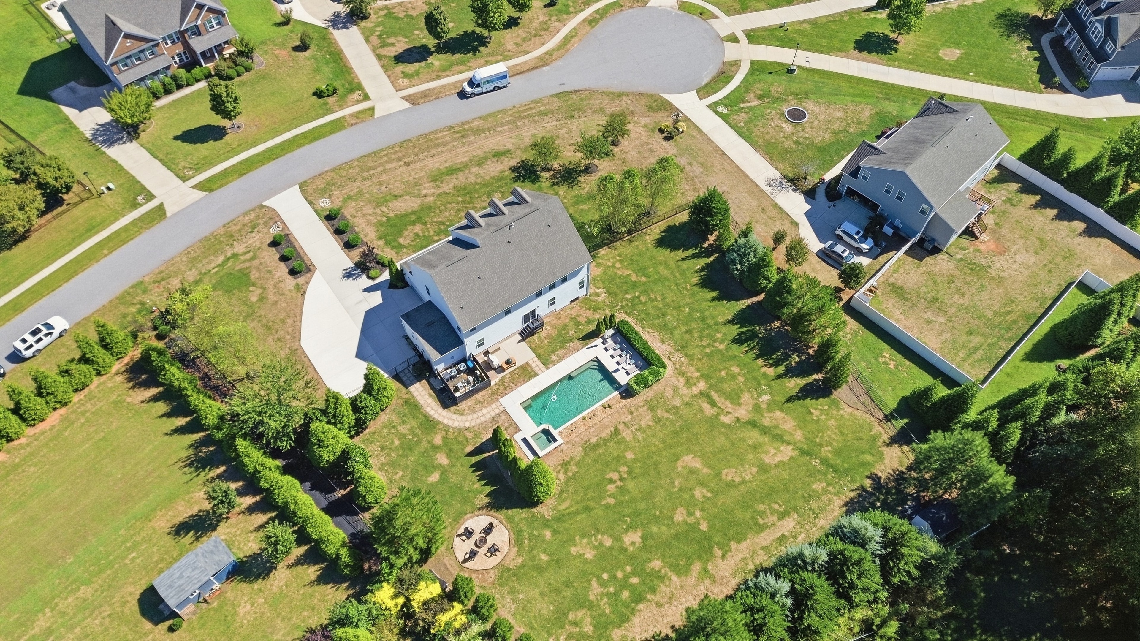 Aerial view of 912 Manorwood Drive showing the full 0.94-acre lot, pool, and surrounding tree line